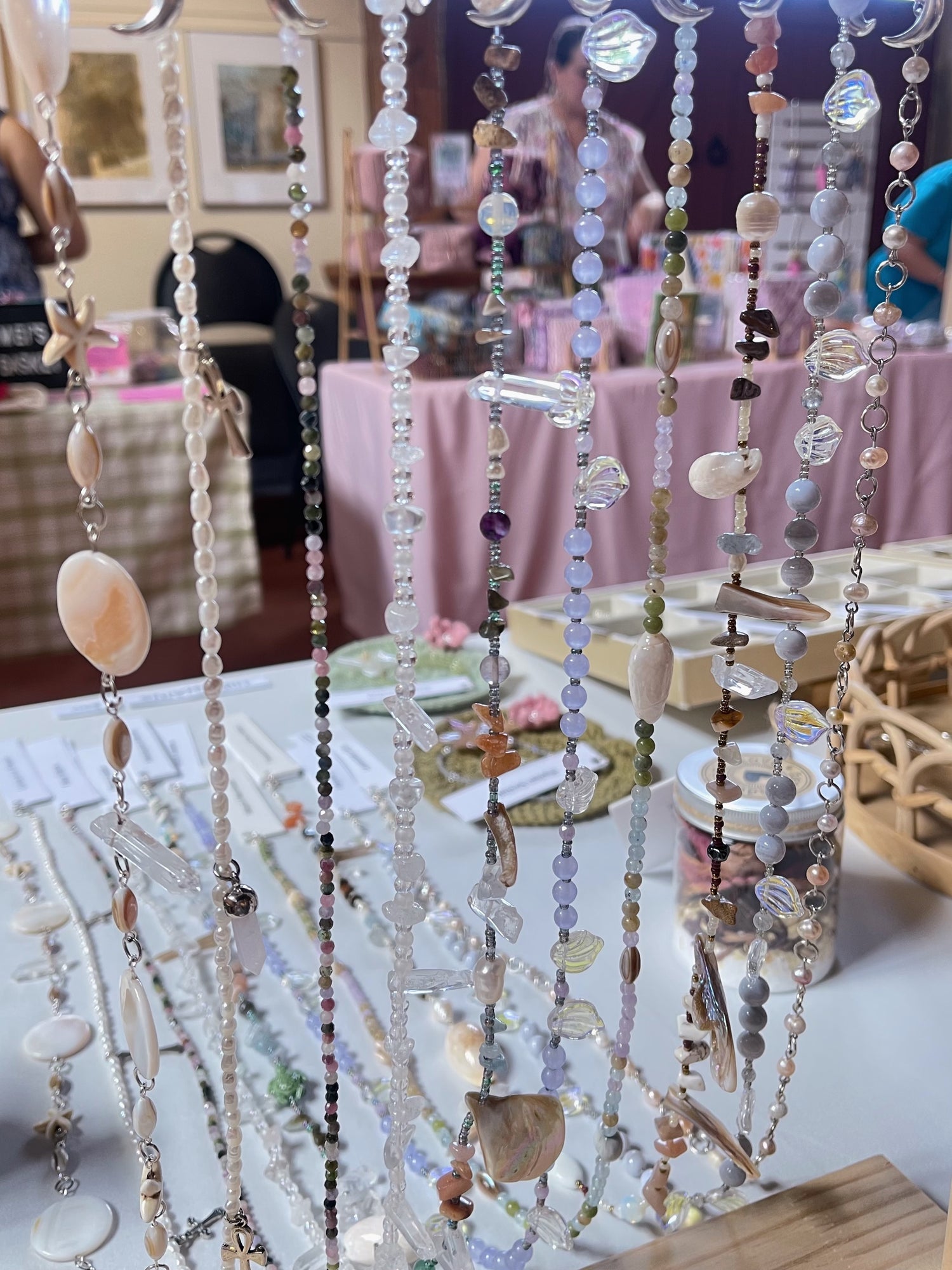 Beaded crystal hip chains on display at a vendor market