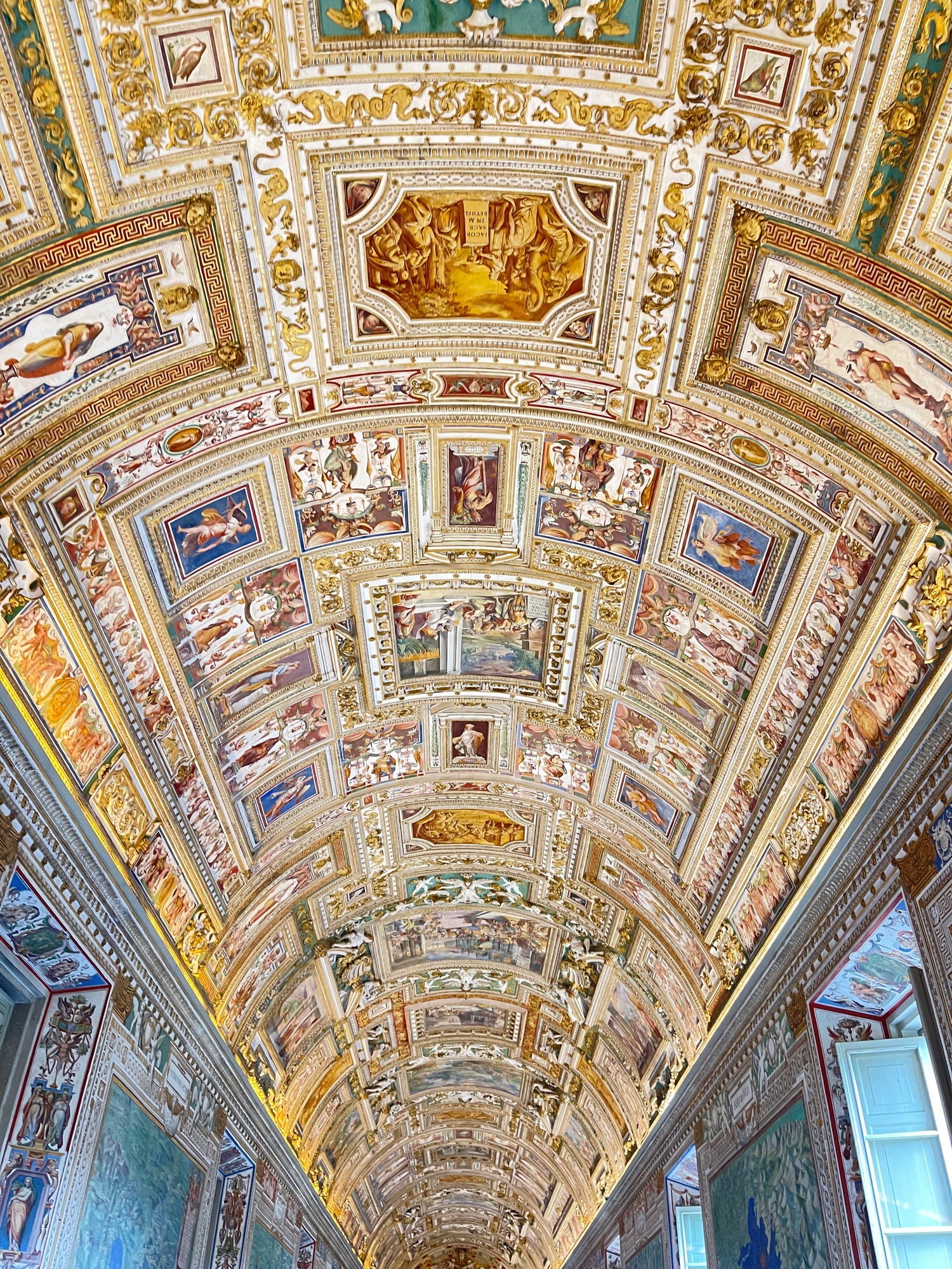 Decorative ceiling with intricate paintings and gold accents